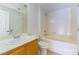 Bathroom with a soaking tub and single sink vanity with oak cabinets at 5855 Valley Dr # 2145, North Las Vegas, NV 89031
