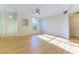 Bright primary bedroom with wood-look floors, ceiling fan and a window with neighborhood views at 5855 Valley Dr # 2145, North Las Vegas, NV 89031
