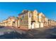 Beige stucco townhome with a red tile roof and lush desert landscaping in front at 5855 Valley Dr # 2145, North Las Vegas, NV 89031