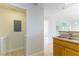 Hallway with wood laminate floors, utility closet with a washer/dryer, leading to the kitchen and living area at 5855 Valley Dr # 2145, North Las Vegas, NV 89031