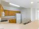 Bright kitchen featuring oak cabinets, a breakfast bar, and white appliances at 5855 Valley Dr # 2145, North Las Vegas, NV 89031