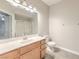 Bathroom featuring a vanity, toilet, large mirror, and shower/tub combo at 6160 Rumrill St # 215, Las Vegas, NV 89113