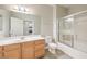 Bathroom featuring a vanity, toilet, mirror, and bathtub/shower combo with glass sliding doors at 6160 Rumrill St # 215, Las Vegas, NV 89113