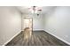 Bedroom with wood-look floors, ceiling fan, and doorway to walk-in closet at 6160 Rumrill St # 215, Las Vegas, NV 89113