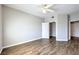 Bedroom featuring wood-look floors, a ceiling fan, and walk-in closet at 6160 Rumrill St # 215, Las Vegas, NV 89113