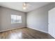 Bedroom featuring wood-look floors, ceiling fan, and window with blinds at 6160 Rumrill St # 215, Las Vegas, NV 89113