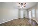 Spacious bedroom featuring wood-look floors, a ceiling fan, and a walk-in closet at 6160 Rumrill St # 215, Las Vegas, NV 89113