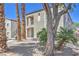 Exterior view showcasing the building's facade with landscaping, trees, and visible unit numbers at 6160 Rumrill St # 215, Las Vegas, NV 89113