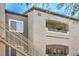 Exterior view of the multi-level apartments featuring staircases and charming balcony at 6160 Rumrill St # 215, Las Vegas, NV 89113