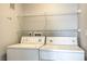Bright laundry room featuring a washer, dryer, and shelving, perfect for efficient home organization at 6160 Rumrill St # 215, Las Vegas, NV 89113