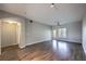 Inviting living room with wood-look flooring, ceiling fan, and natural light from the sliding glass door at 6160 Rumrill St # 215, Las Vegas, NV 89113