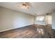 Expansive living room with wood-look floors, modern light fixtures, and an open flow into the updated kitchen at 6160 Rumrill St # 215, Las Vegas, NV 89113