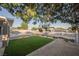 This backyard features a pristine pool, a patch of lush green artificial turf, and neutral rock landscaping at 617 6Th St, Boulder City, NV 89005