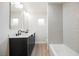 Nicely appointed bathroom with double vanity, tile surround tub, and modern fixtures at 617 6Th St, Boulder City, NV 89005
