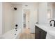 Bright bathroom featuring a tub with tile surround and black fixtures and dark cabinets at 617 6Th St, Boulder City, NV 89005