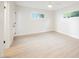 Bright and neutral bedroom features light wood floors and two windows at 617 6Th St, Boulder City, NV 89005