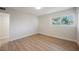 Neutral bedroom with light wood floors and large window bringing in natural light at 617 6Th St, Boulder City, NV 89005