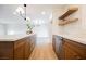 Modern kitchen with wood cabinets, stainless steel appliances, quartz counters and wood floating shelves at 617 6Th St, Boulder City, NV 89005