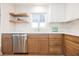 Well-lit kitchen featuring stainless steel appliances, wood cabinets and floating shelves at 617 6Th St, Boulder City, NV 89005