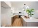 Bright kitchen with a large island, stainless steel appliances, two-tone cabinets, and modern lighting at 617 6Th St, Boulder City, NV 89005