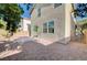 A backyard featuring desert landscaping, a concrete patio, and access gate on the side of the house at 6264 Canebrake Ct, Las Vegas, NV 89141