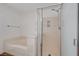Bathroom featuring shower and soaking tub with marble surround and modern fixtures at 6264 Canebrake Ct, Las Vegas, NV 89141