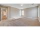 Bright carpeted bedroom featuring neutral paint, and ample natural light from the window at 6264 Canebrake Ct, Las Vegas, NV 89141