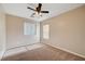 Neutral bedroom featuring a ceiling fan, window with blinds, and neutral carpeting at 6264 Canebrake Ct, Las Vegas, NV 89141