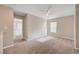 Large carpeted bedroom featuring a ceiling fan, neutral paint and natural light from the window at 6264 Canebrake Ct, Las Vegas, NV 89141