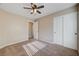 Neutral bedroom featuring a ceiling fan, double door closet, and neutral carpeting at 6264 Canebrake Ct, Las Vegas, NV 89141