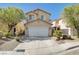 Charming two-story home featuring a two-car garage, tile roof, and low maintenance landscaping at 6264 Canebrake Ct, Las Vegas, NV 89141