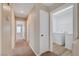 Upstairs hallway featuring carpeted floors, a linen closet, and a laundry room at 6264 Canebrake Ct, Las Vegas, NV 89141
