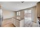 Bright kitchen area features an island, wood-look flooring and sliding glass doors to the backyard at 6264 Canebrake Ct, Las Vegas, NV 89141