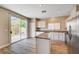 Modern kitchen featuring stainless steel appliances, a center island, and access to the yard at 6264 Canebrake Ct, Las Vegas, NV 89141