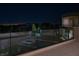 Night view of a modern backyard featuring a pool, manicured lawn, and sleek design at 68 Sun Glow Ln, Las Vegas, NV 89135
