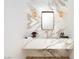 Elegant bathroom with marble countertop and backsplash, crystal sconces, and modern gold trimmed mirror at 68 Sun Glow Ln, Las Vegas, NV 89135