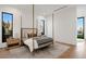 Stylish bedroom featuring a four poster bed, sleek modern design, and two windows at 68 Sun Glow Ln, Las Vegas, NV 89135