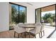 Bright breakfast nook with a modern round table and views of the outdoors through floor-to-ceiling windows at 68 Sun Glow Ln, Las Vegas, NV 89135