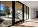 Bright entryway with large glass doors framing the desert landscape, seamlessly blending indoor and outdoor spaces at 68 Sun Glow Ln, Las Vegas, NV 89135