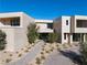 Contemporary home featuring a minimalist design with desert landscaping, offering a serene and stylish outdoor space at 68 Sun Glow Ln, Las Vegas, NV 89135