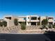 Stunning modern home with clean lines, desert landscaping, and a grand entrance creating a sophisticated curb appeal at 68 Sun Glow Ln, Las Vegas, NV 89135