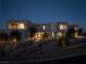 Contemporary home at dusk featuring manicured landscaping and well-lit entryways at 68 Sun Glow Ln, Las Vegas, NV 89135