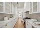 Modern kitchen with marble countertops, white cabinets, and stainless steel appliances, offering ample space and style at 68 Sun Glow Ln, Las Vegas, NV 89135