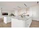 Open kitchen with marble countertops, white cabinetry, a large island, and modern appliances offering style and functionality at 68 Sun Glow Ln, Las Vegas, NV 89135
