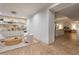Spacious living area featuring light wood floors, a built-in bar, and modern furnishings at 68 Sun Glow Ln, Las Vegas, NV 89135