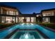 Modern home with a sleek pool featuring water fountains and clear views into the house at 68 Sun Glow Ln, Las Vegas, NV 89135