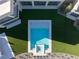 Aerial view of a modern pool with geometric design and lush green landscaping at 68 Sun Glow Ln, Las Vegas, NV 89135