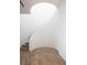 Unique curved staircase with wood floors and white walls, showcasing modern architectural design at 68 Sun Glow Ln, Las Vegas, NV 89135