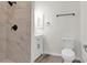 Modern bathroom features a marble tile shower, updated vanity, and fixtures with neutral paint and wood look flooring at 6909 Fruit Flower Ave, Las Vegas, NV 89130