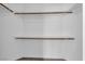 A functional walk-in closet with wood racks and shelving, perfect for organizing clothing and accessories at 6909 Fruit Flower Ave, Las Vegas, NV 89130